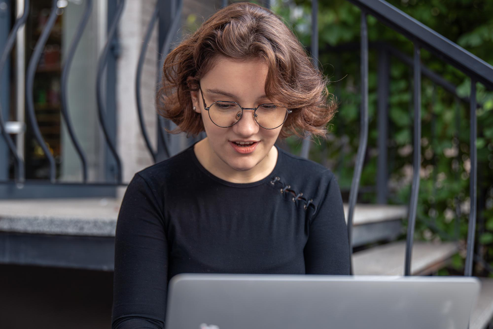 Person working on a laptop outdoors