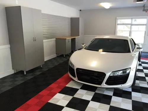 car parked on grey and black garage flooring tiles. 