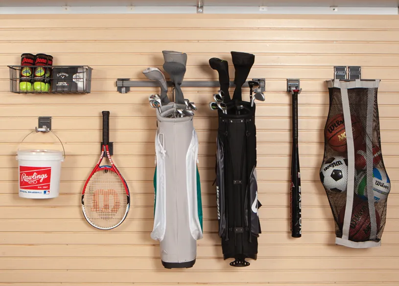 tan garage slatwall with items hanging from it. 