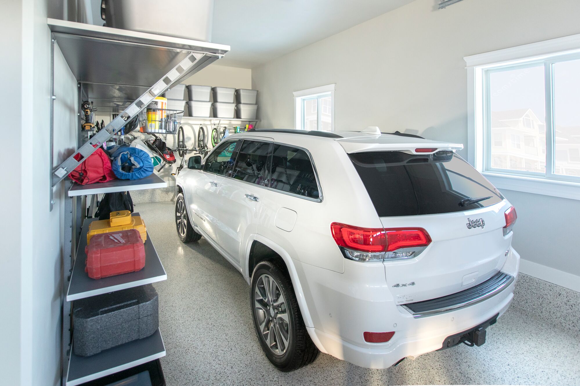 Organized one car garage with garage shelving. 