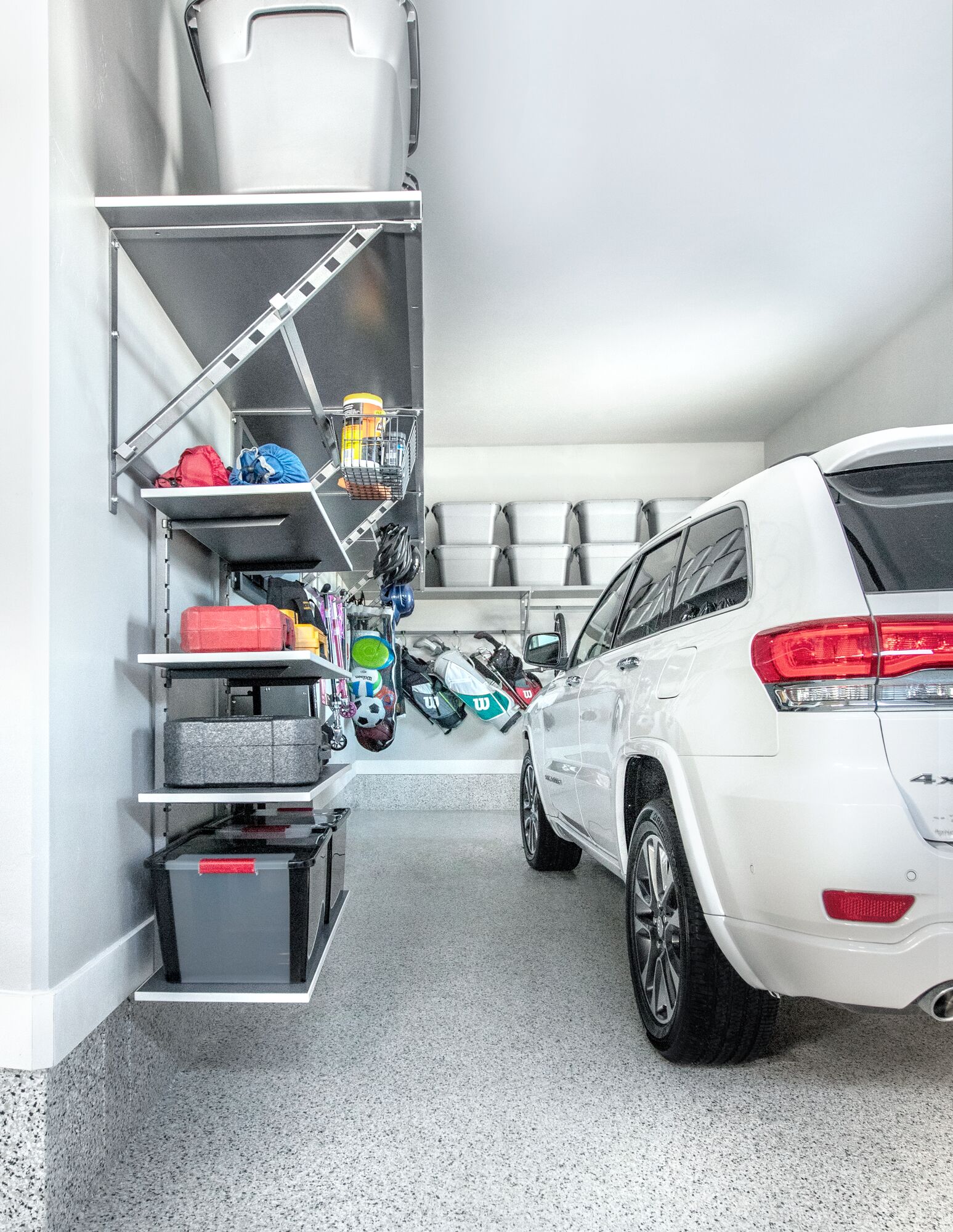 Organized one car garage with close up of garage shelving. 