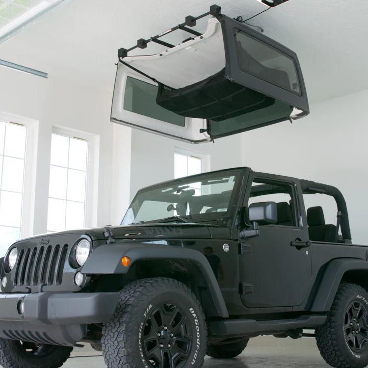 hard top lifter in Sarasota, FL lifting a hard top off of a Jeep.