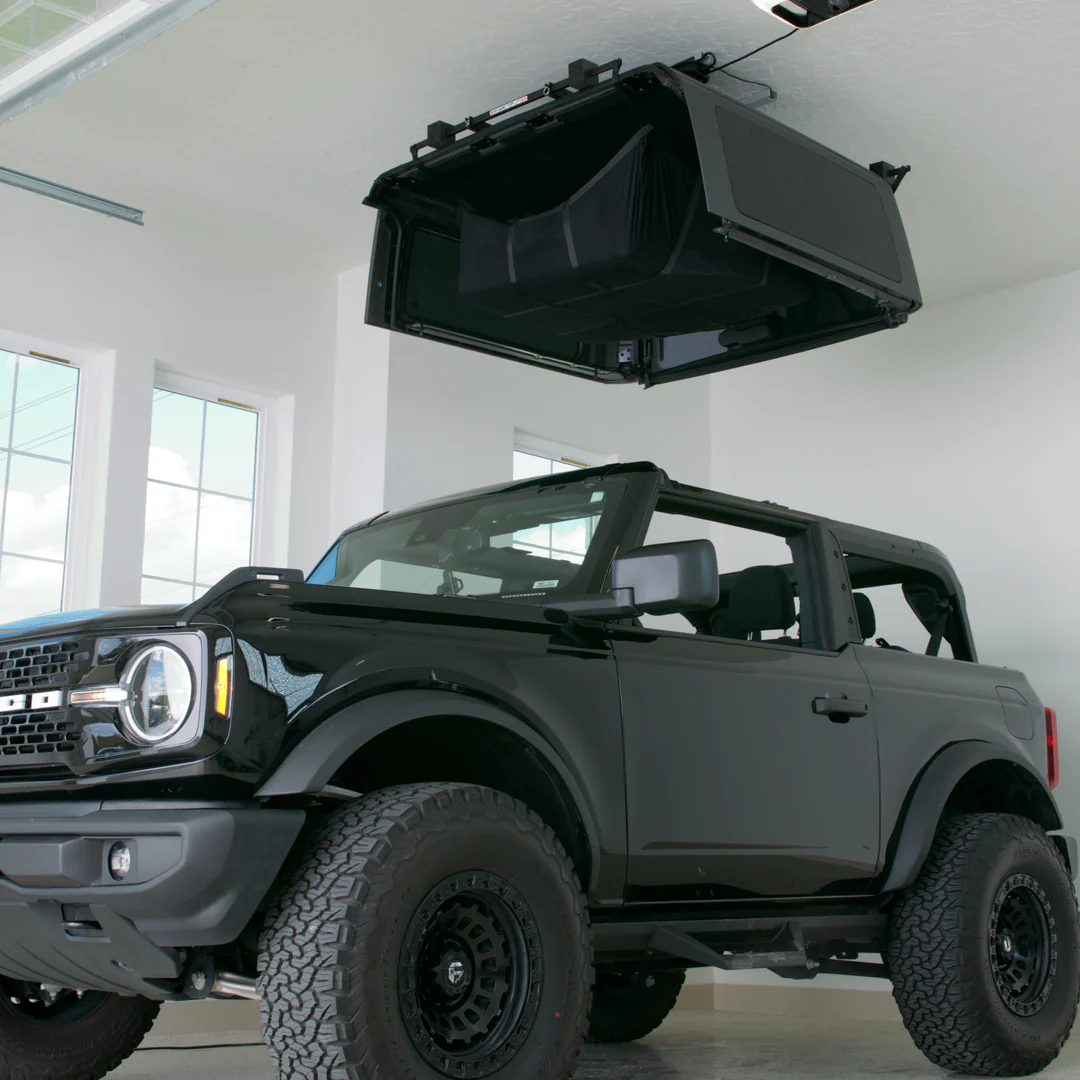 Hard top lifter lifting up a Bronco hard top. 