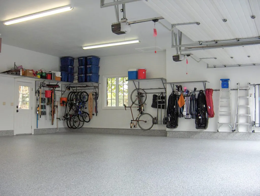 Garage shelving with sports equipment hanging from the roof. 