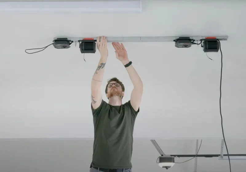 Man installing a hard top lifter system. 