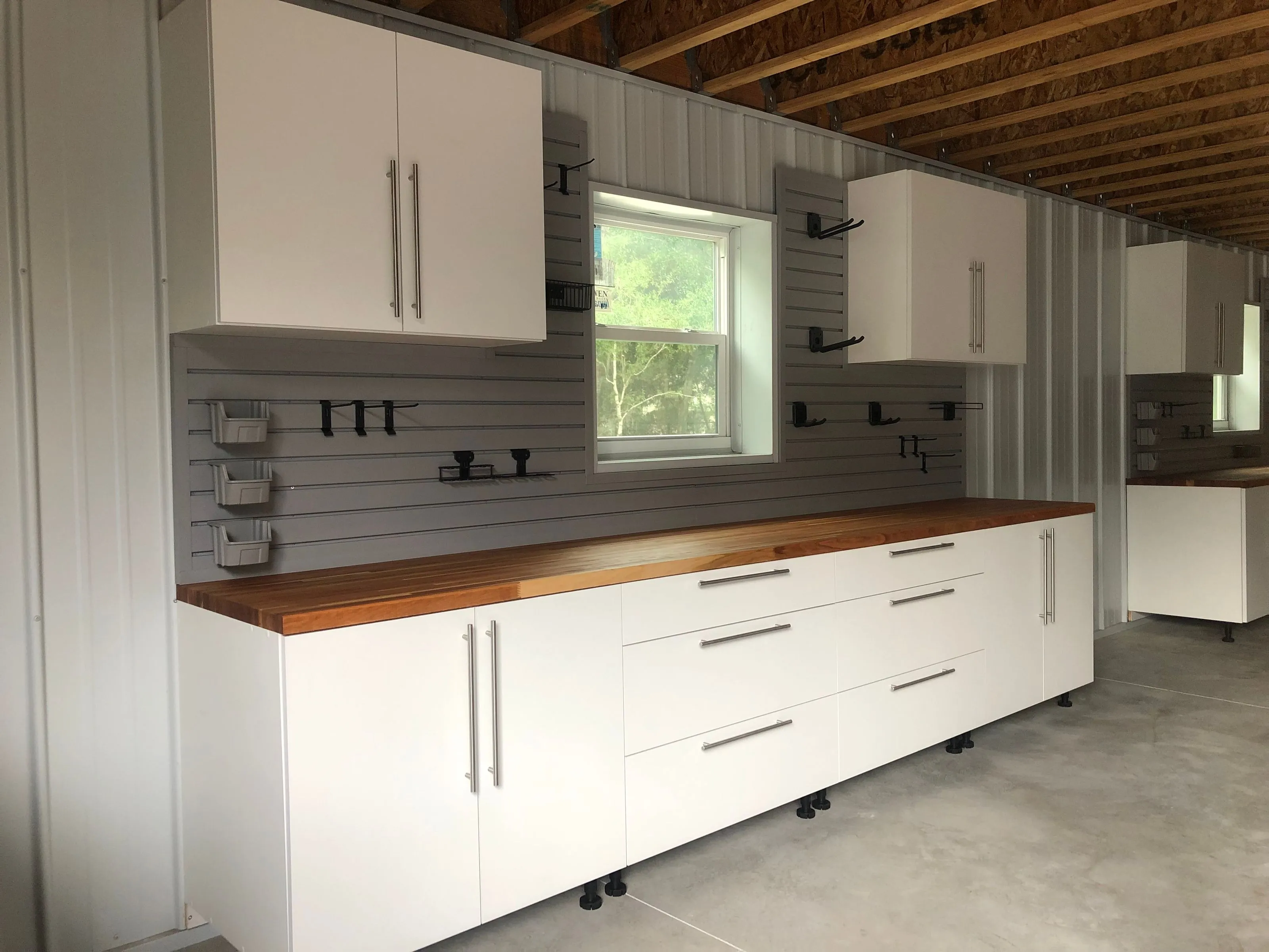 garage with custom garage floor and garage cabinets for storage