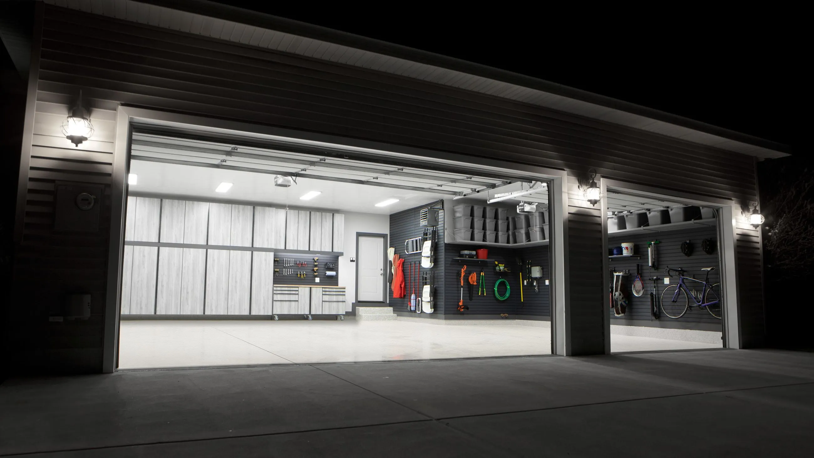 looking into a finished garage  with white cabinets and epoxy flooring. 