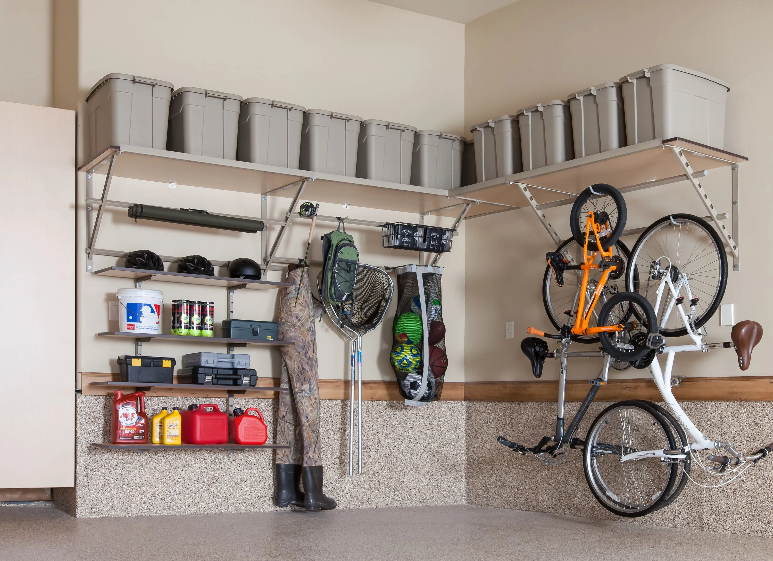 Overhead garage shelving with bikes hanging from it. 