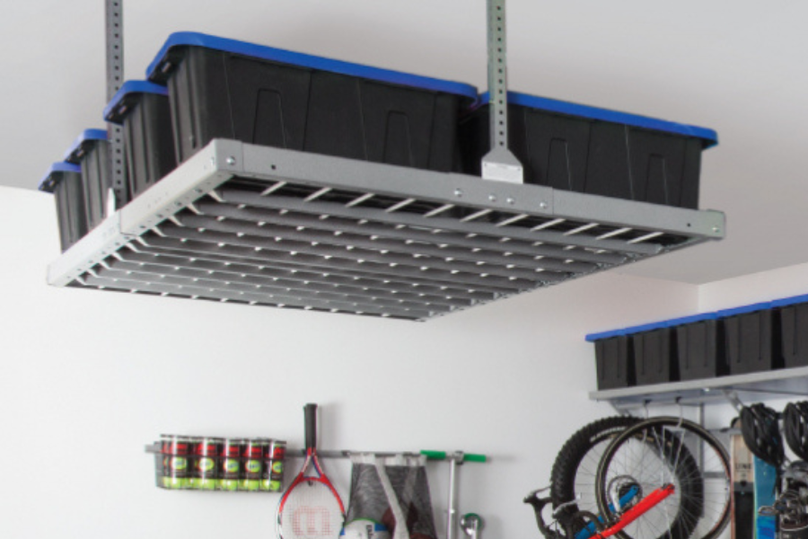 A sturdy, stationary ceiling-mounted storage rack holding large black and blue bins in a well-organized garage. Overhead storage solutions help free up floor space and keep seasonal items neatly stored.