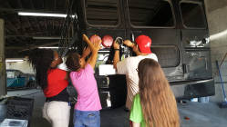 DHS students helping paint school bus