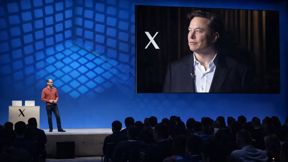 Elon Musk on screen as X takes the stage at a tech conference