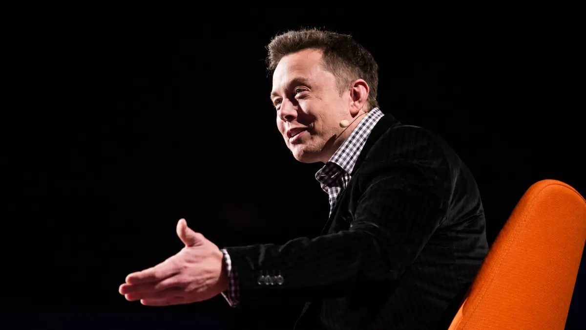 Elon Musk on screen as X takes the stage at a tech conference