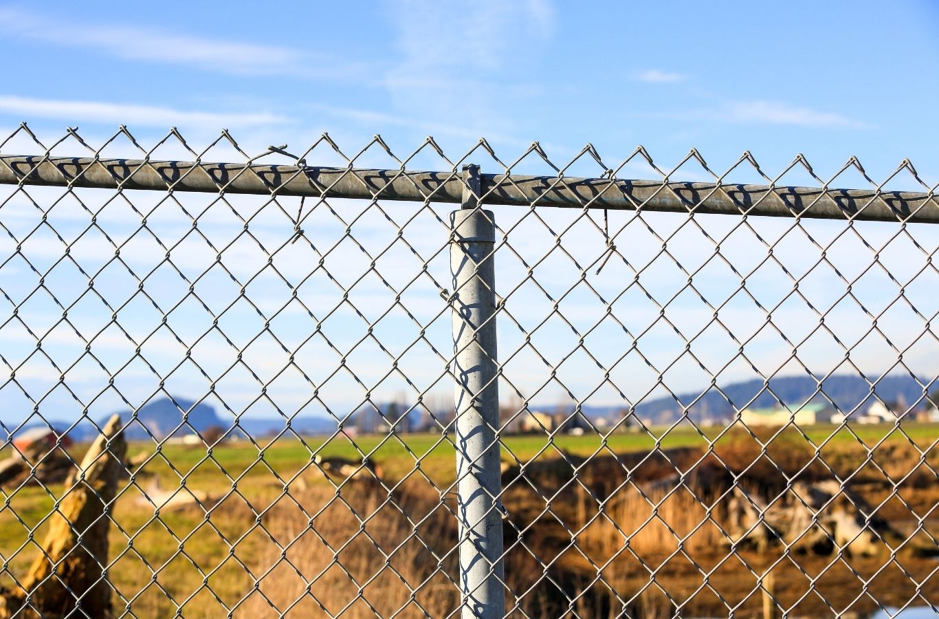 Fence Company of Columbus installer completing chain link fence installation in Lewis Center, OH with accurate post setting and alignment. Chain Link Fence Installation Near Me.