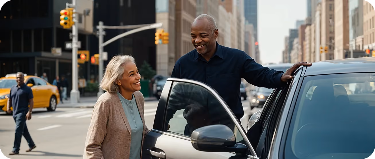 Man helping a woman into a car on a city street.