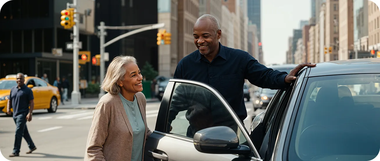 Man helping a woman into a car on a city street.