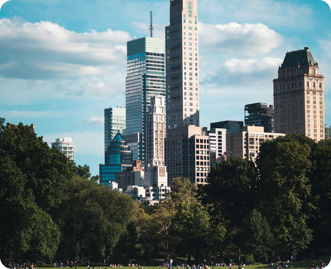 A large city with a tall building and a park.