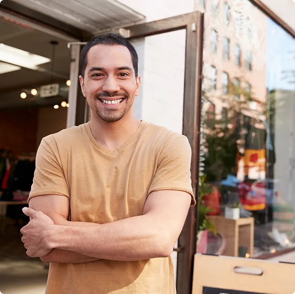 A man in a yellow shirt posing for a picture.