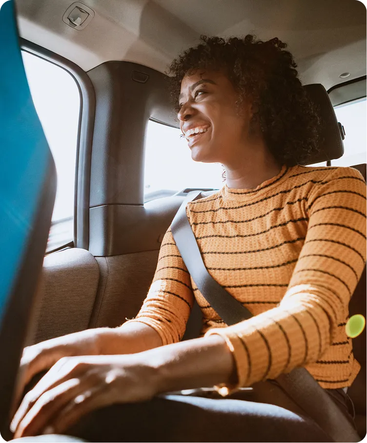 a woman in a car smiling