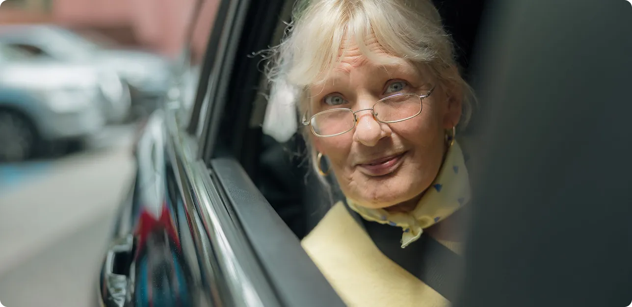a woman looking out a car window