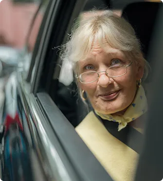 a woman looking out a car window