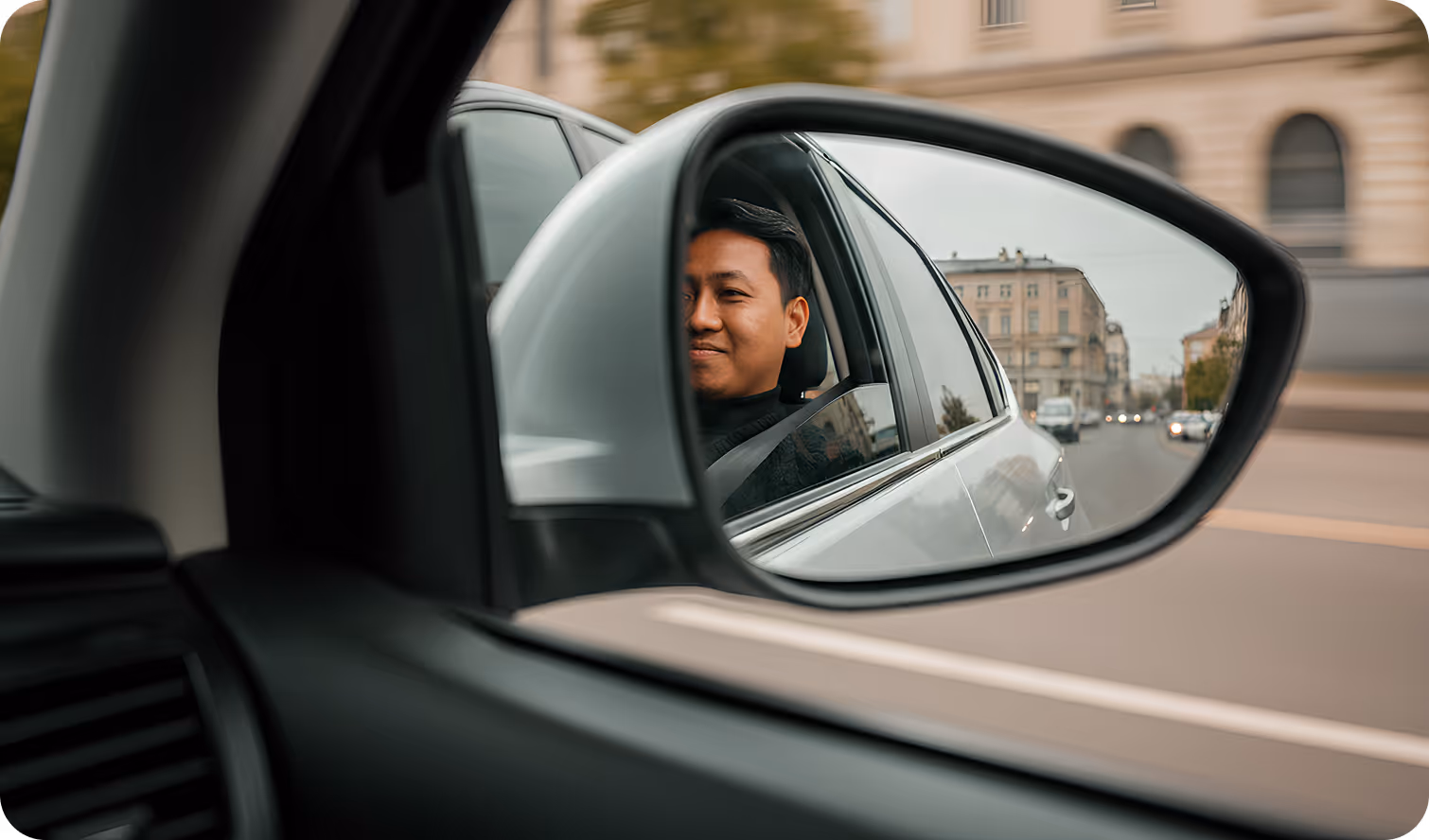 a man in a car mirror