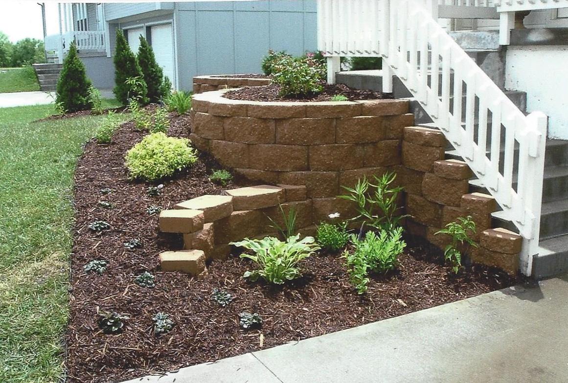 Mulch bed with retaining wall