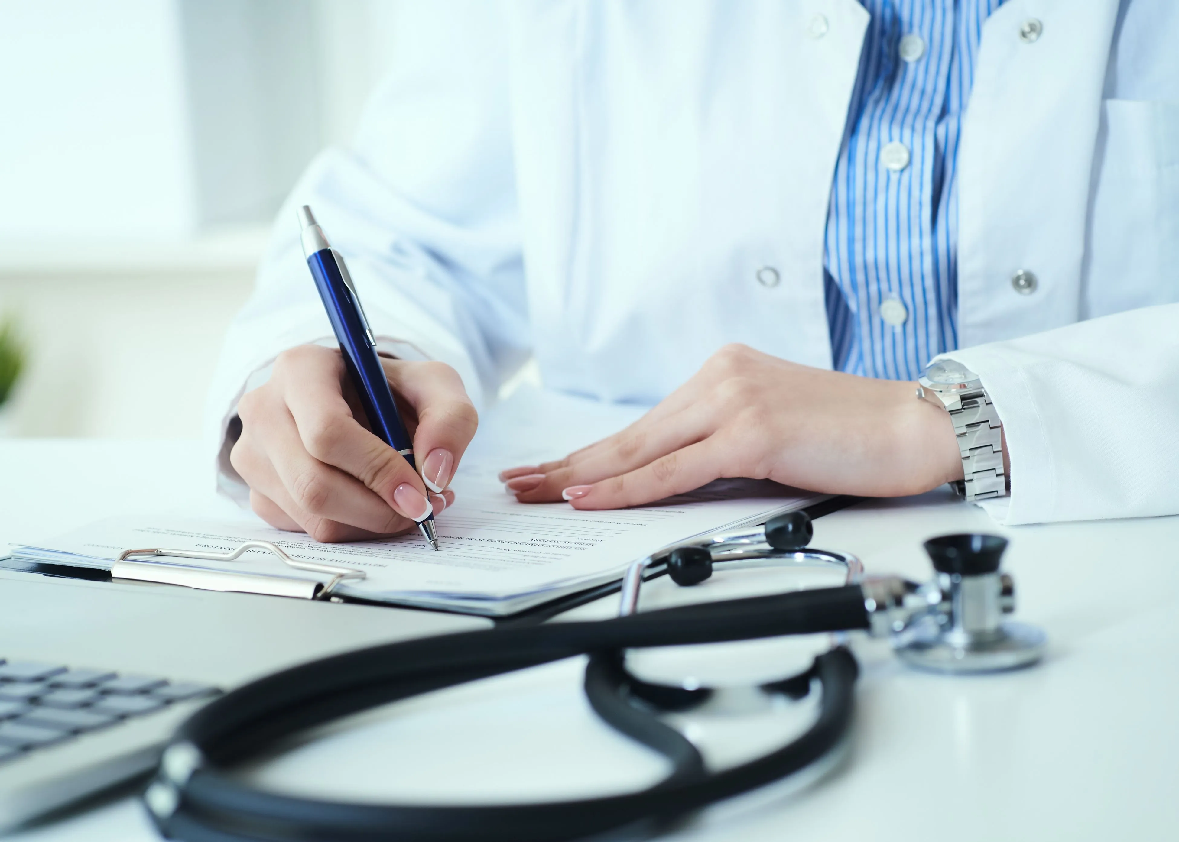 A doctor writing on a piece of paper