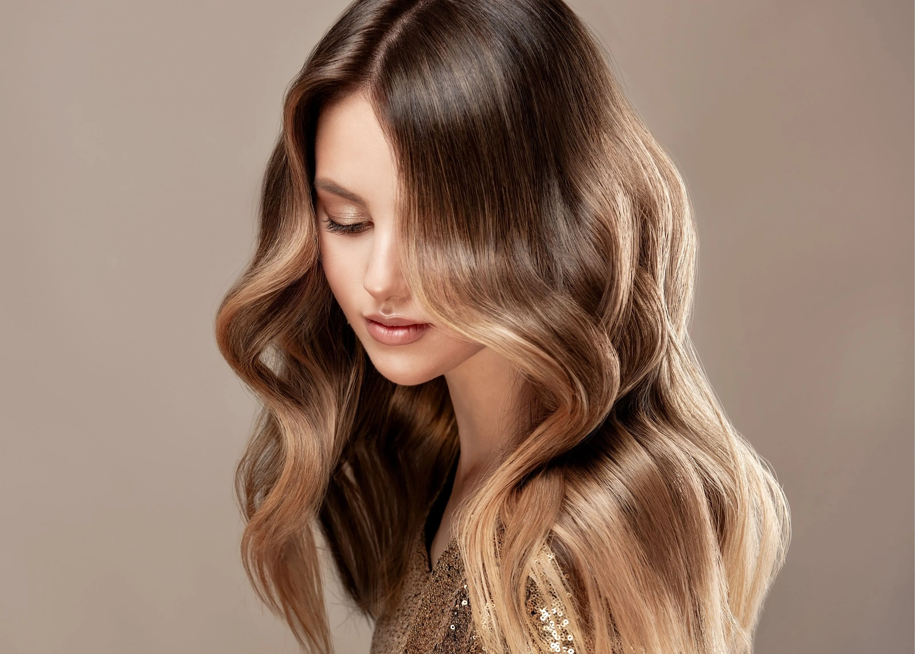 A woman looking down with her hair covering part of her face