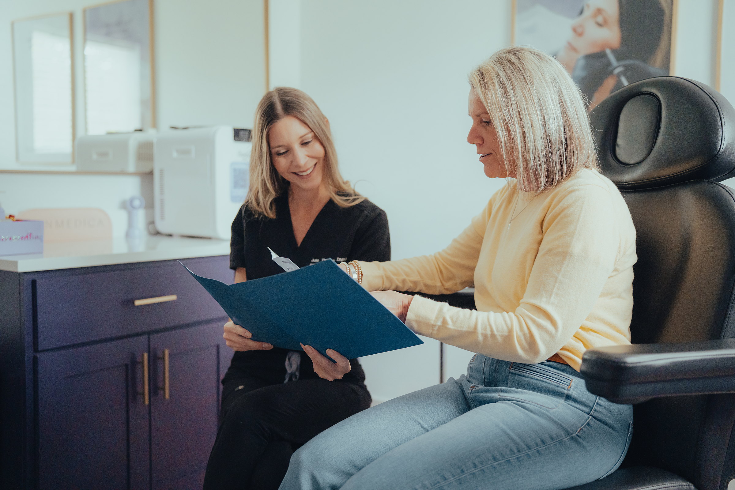A Beauty Barn provider reviewing a personalized treatment plan with a client during a consultation