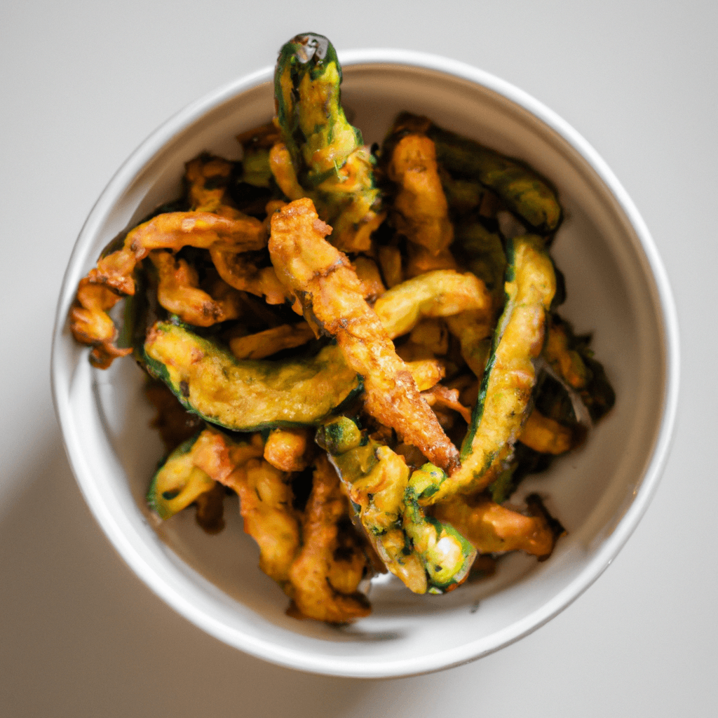 Courgette fries in the air fryer basket ready to serve
