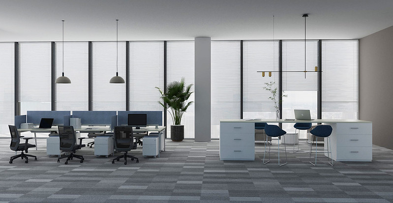 Friant benching workstations with blue fabric panels beside floor to ceiling windows