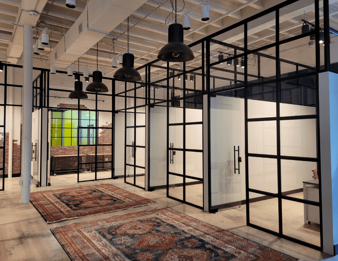 Teilen black grid steel and glass partition walls in a loft style office