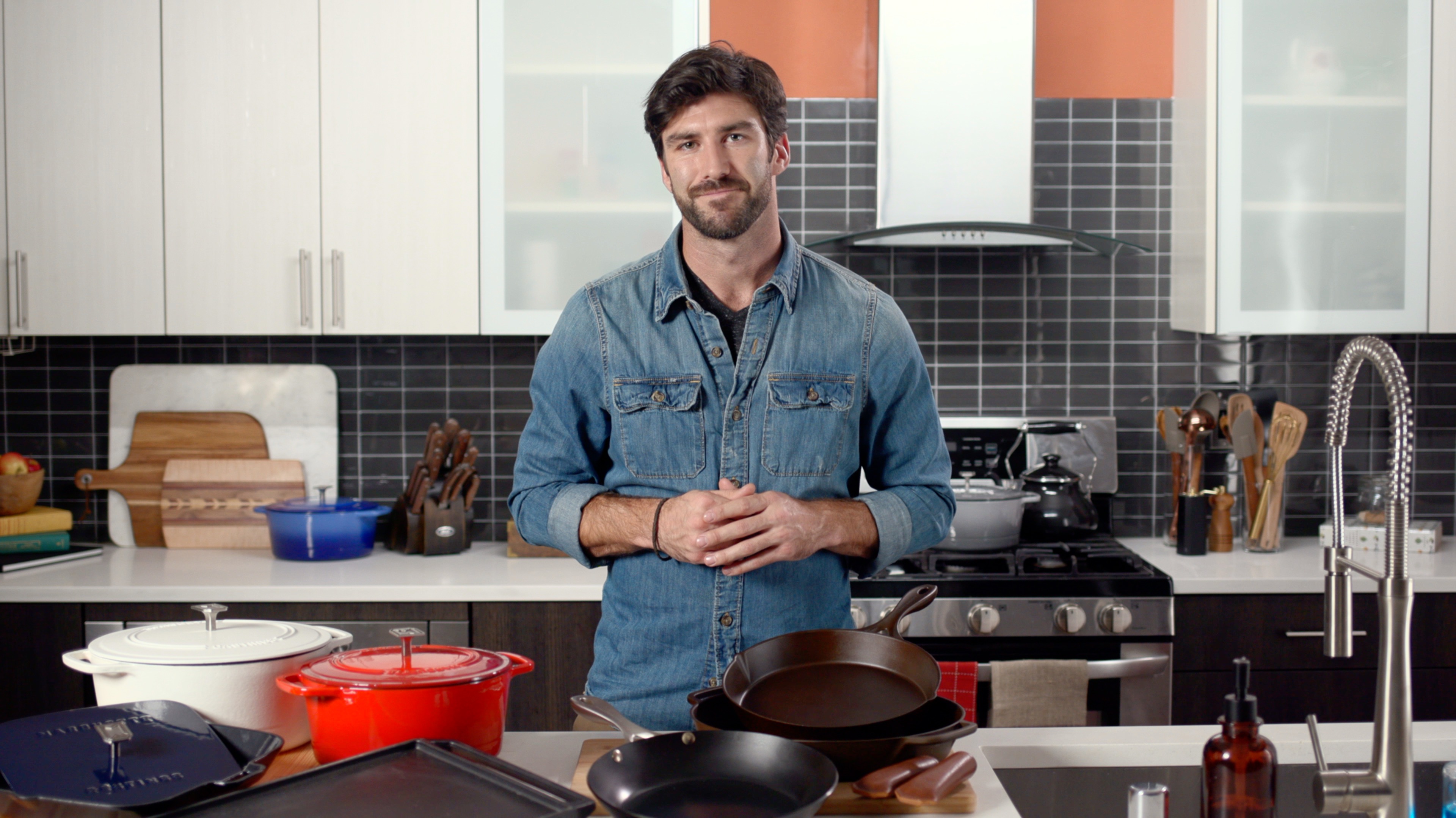 Man stands in front of cookware