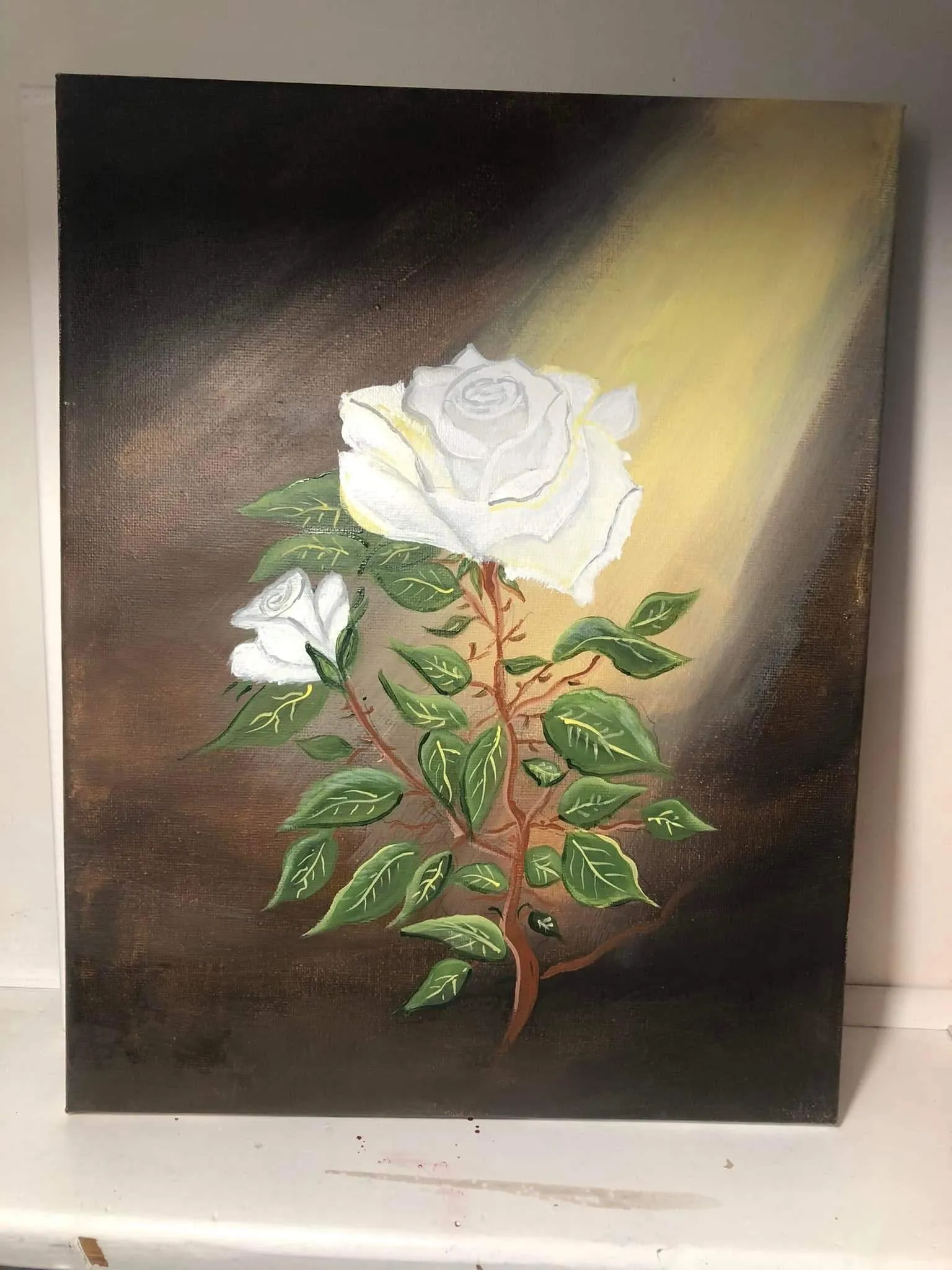 Canvas painting of two white roses bathed in golden sunlight with green foliage.