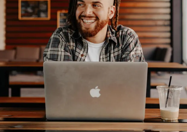 Man working on laptop at coffee shop