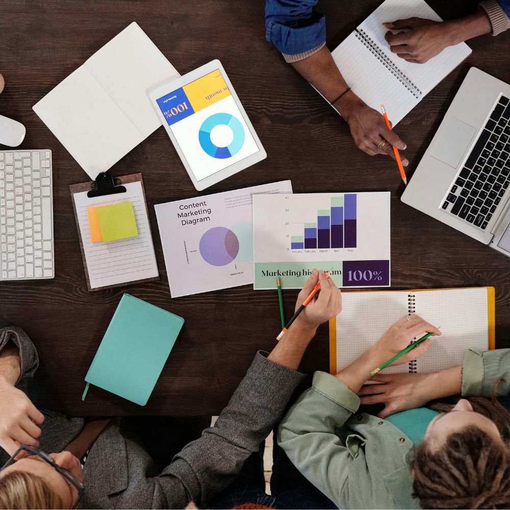 Co-workers reviewing data and graphs around a conference table