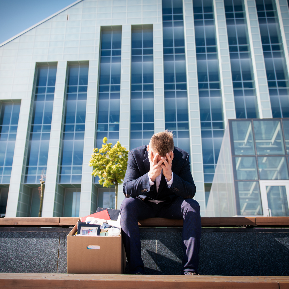 Person sitting outside of business