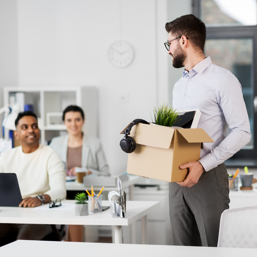 person in office holing a box 