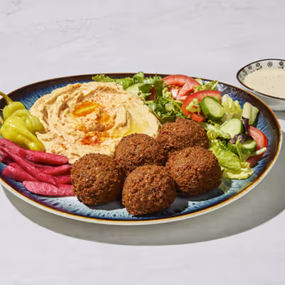 Crispy falafel balls with hummus, fresh salad, and pita bread at The Green Olive.