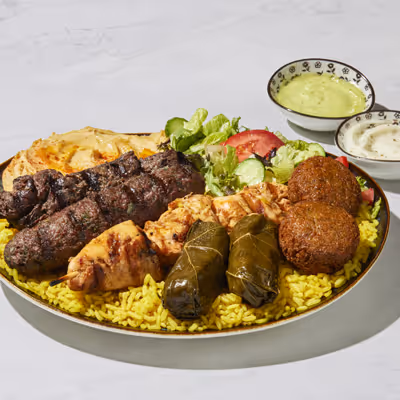The Green Olive Works Platter featuring chicken, steak, lamb gyro, and steak kabob.