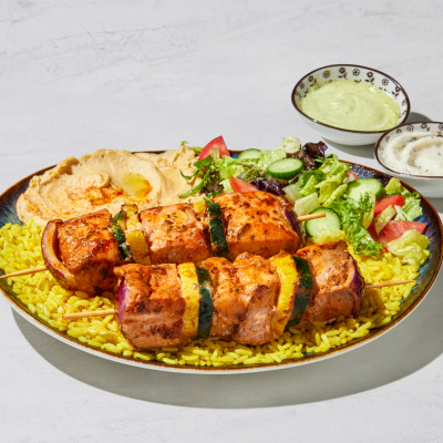 Grilled salmon kabob served with rice, vegetables, and fresh salad from The Green Olive.