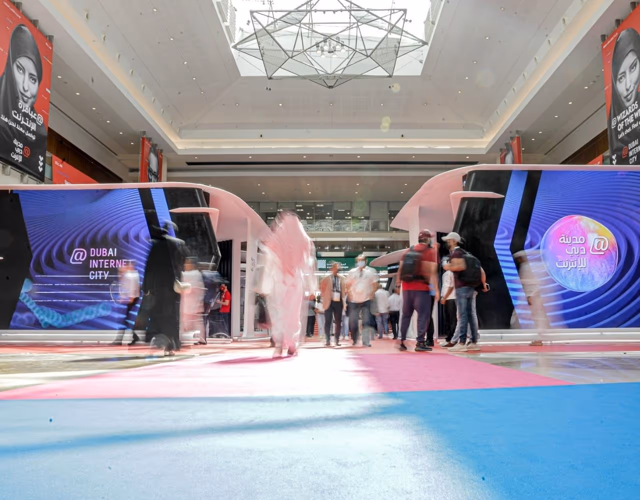 Dubai Internet City tech exhibition with visitors and booths