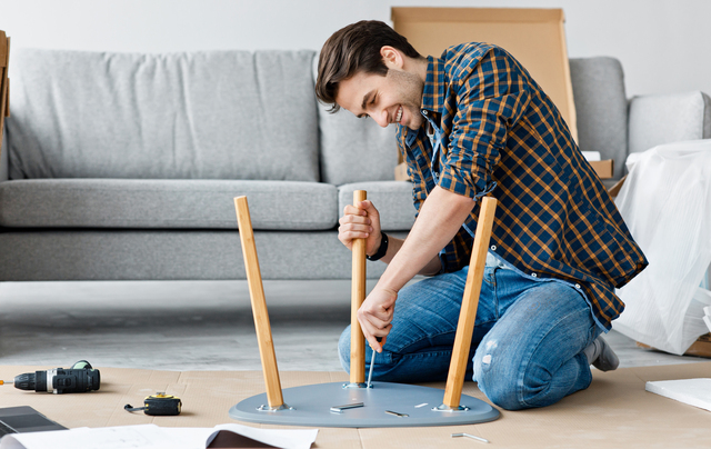 A man disassembling Furniture