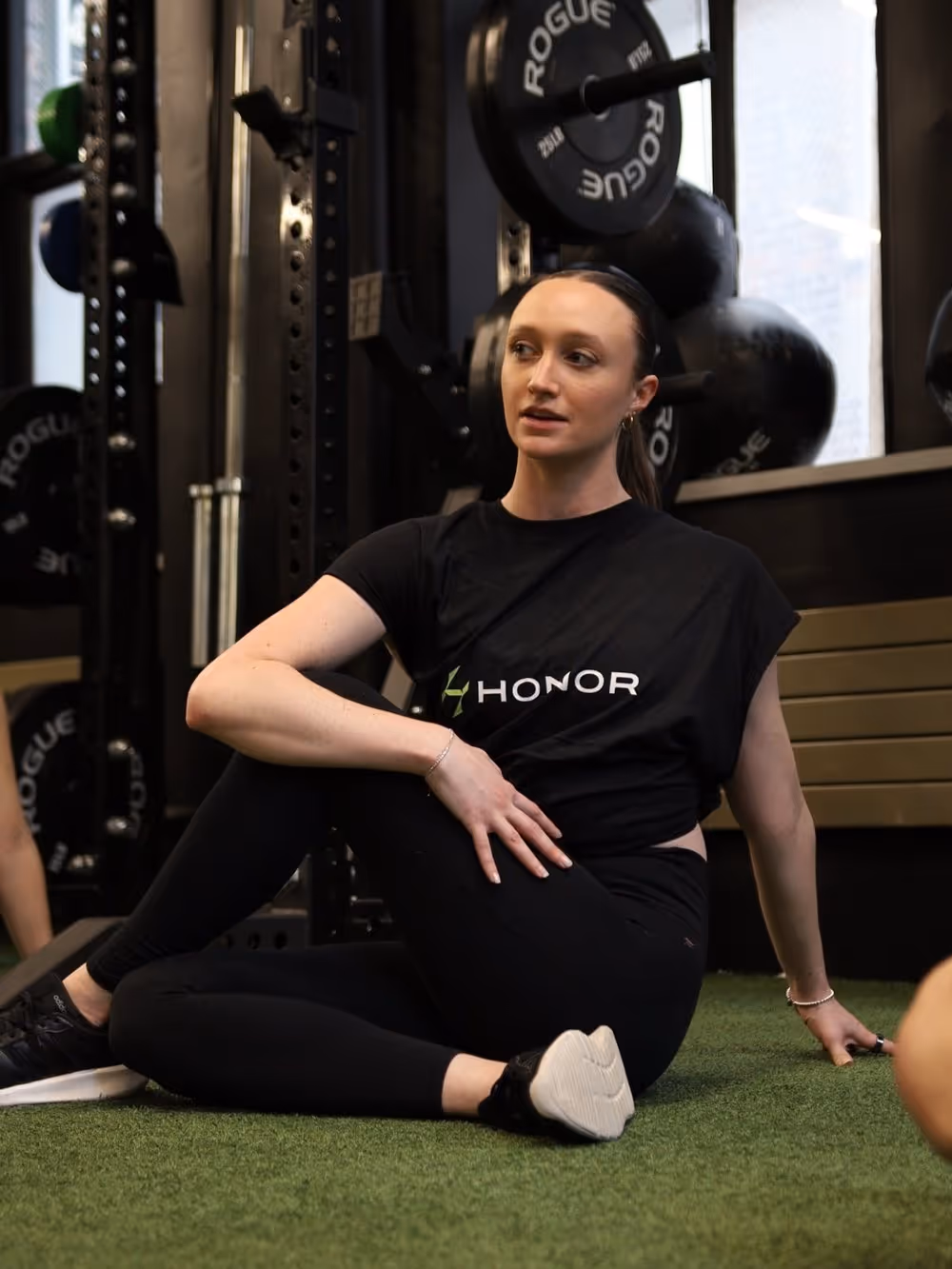the Picture of Carli N in the Gym wearing a black sweat shirt branded in Honors Logo
