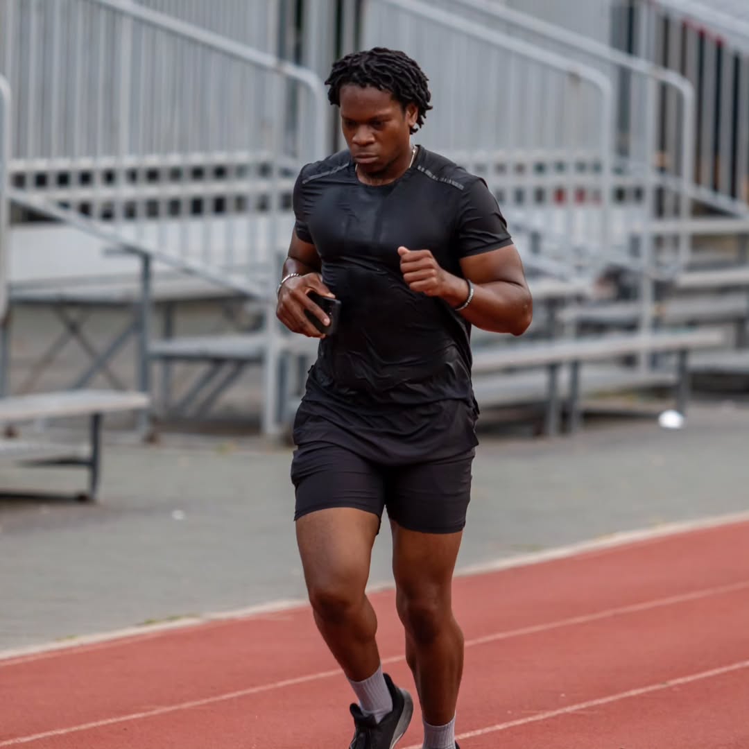 Keyshawn Donacien warming up in the 5th lane of a track and field 