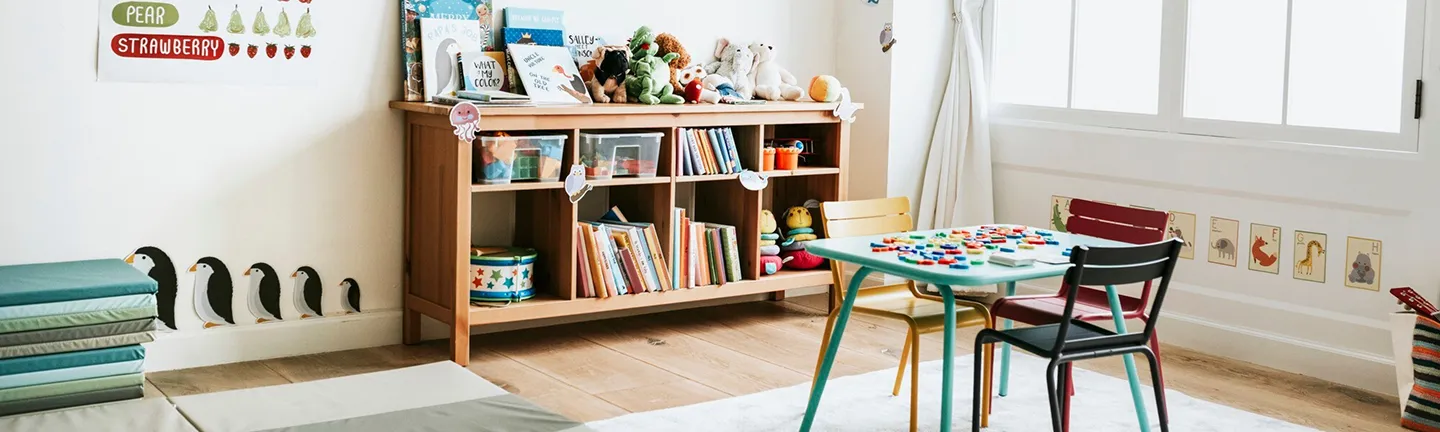 A Room with a lot of books and toys.
