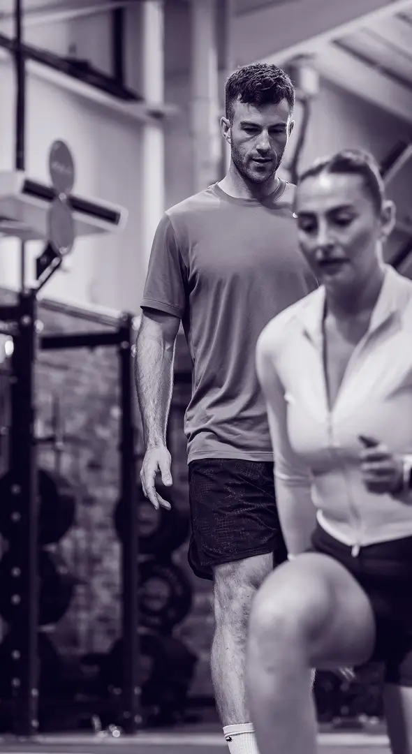 Personal trainer teaching his student lunges