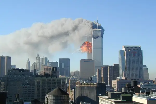 A photo of the second twin tower being struck on 9/11/2001.  Photo captured by John Celardo, hosted at the U.S. National Archives.