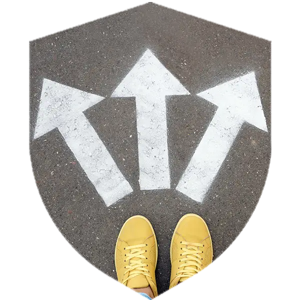 a person in yellow shows stands on asphalt with three arrows pointing in different directions below their feet