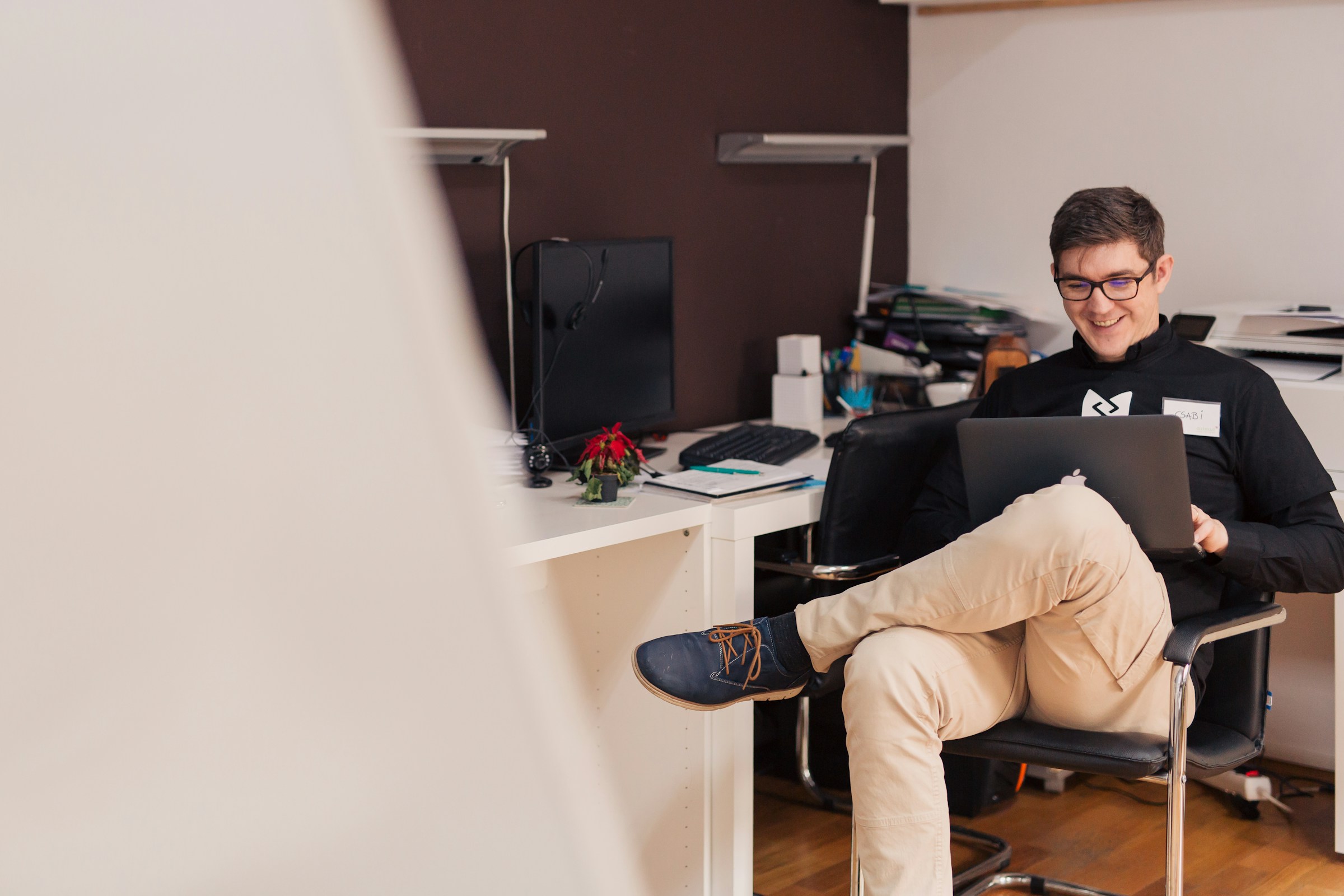 man using a laptop and smiling - How Do You Backtest A Trading Strategy